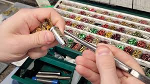 Technician rekeying a deadbolt cylinder at C & E Lock & Safe Inc. in Fayetteville.