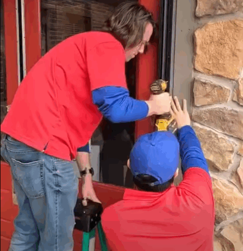 Continuous hinge installation on an aluminum storefront door in Fayetteville.
